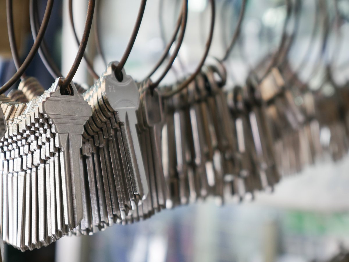 Multiple duplicate keys hanging on wire rings at a locksmith shop