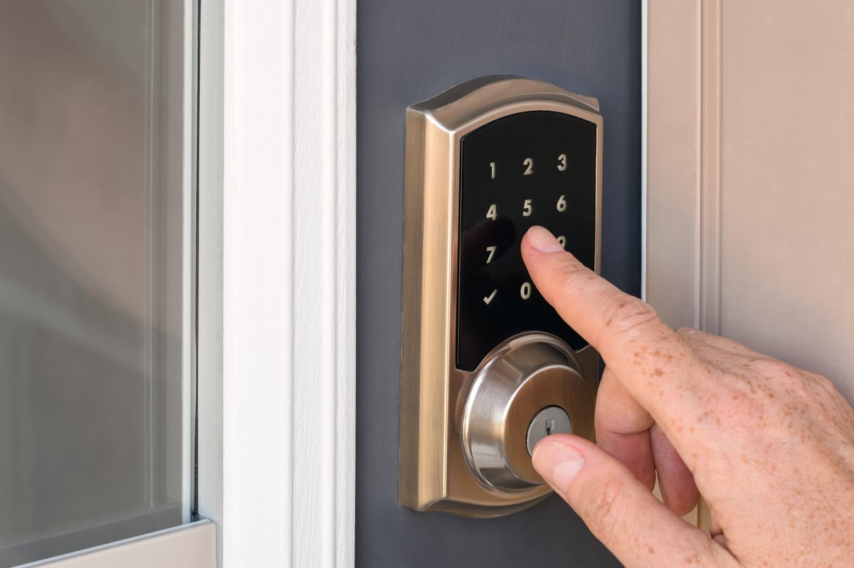 Closeup of a modern smart door lock keypad being accessed on a residential door