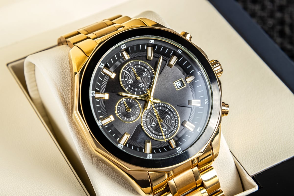 Premium black dial wristwatch with golden hands and metal bracelet